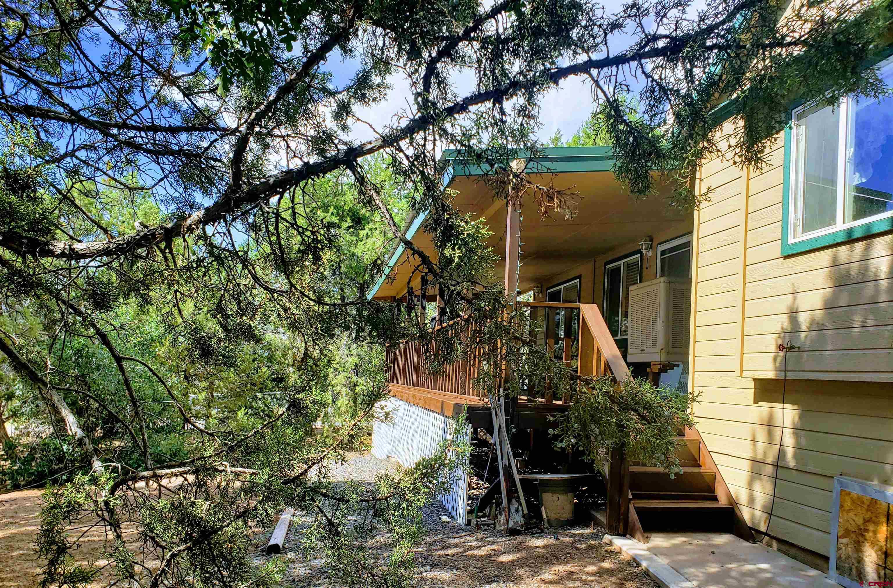 20915 Upland Road Cedaredge, CO 81413 - Photo 9 of 35 a view of a house with a tree