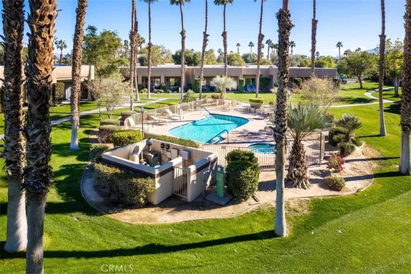 a view of a swimming pool with a yard