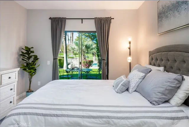 a bed sitting in a bedroom next to a window