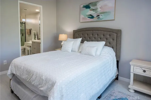 a bed sitting in a bedroom and painting on the wall