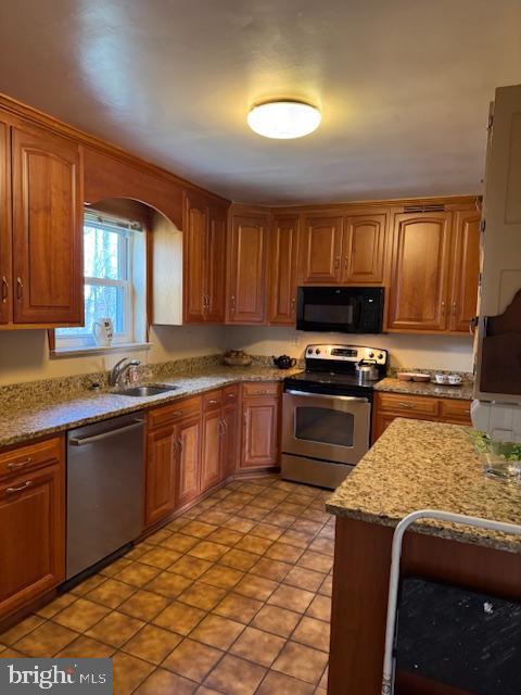 7201 Hawkins Creamery Road Gaithersburg, MD 20882 - Photo 11 of 19 a kitchen with stainless steel appliances granite countertop a stove sink and cabinets