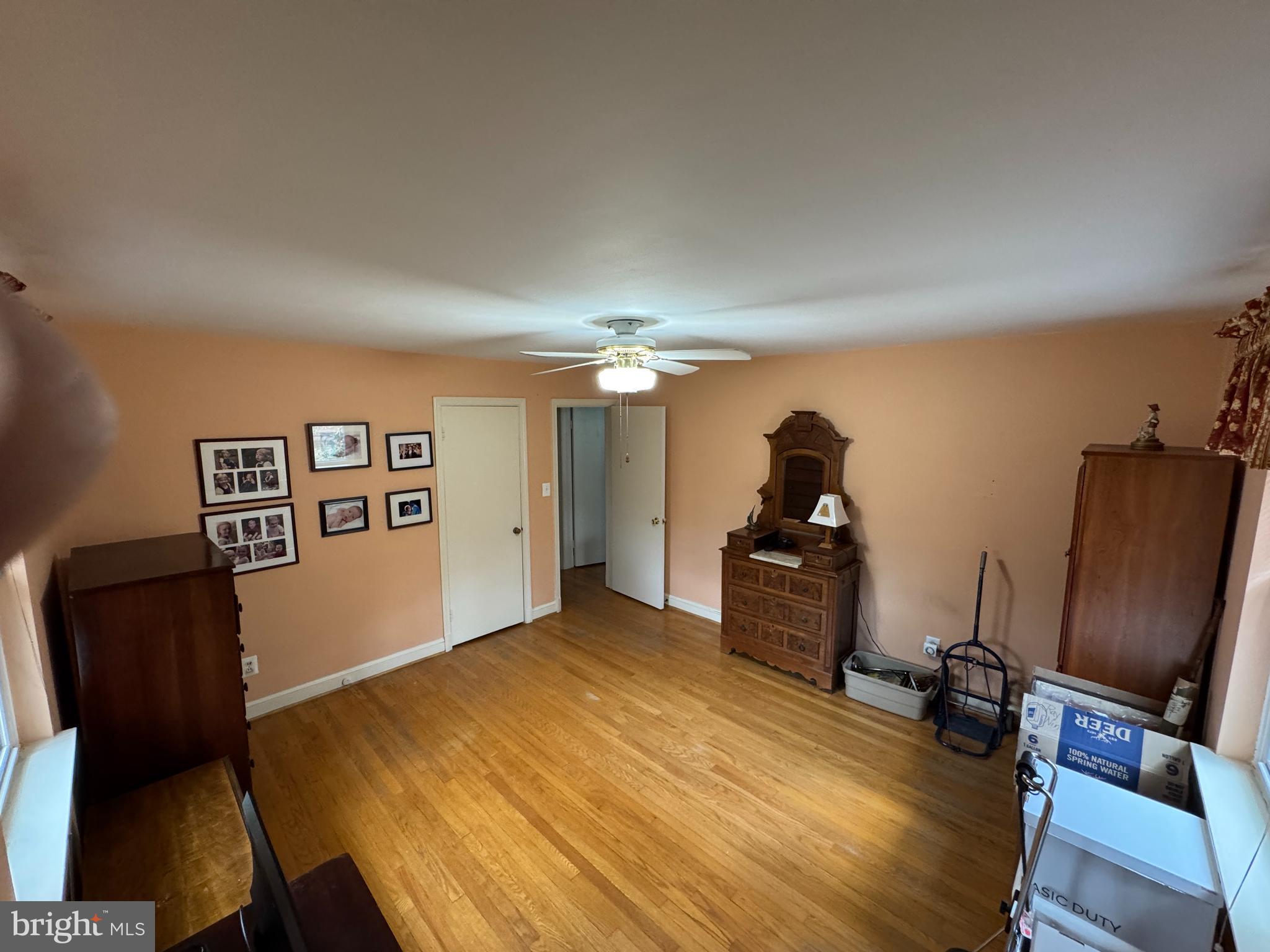 7201 Hawkins Creamery Road Gaithersburg, MD 20882 - Photo 13 of 19 a room with couch chair and wooden floor