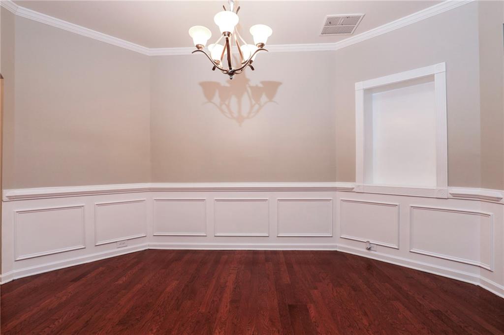 346 Beynon Terrace Suwanee, GA 30024 - Photo 5 of 17 a view of an empty room with wooden floor and a window