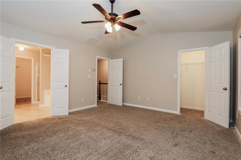 346 Beynon Terrace Suwanee, GA 30024 - Photo 6 of 17 an empty room with closet and a chandelier fan
