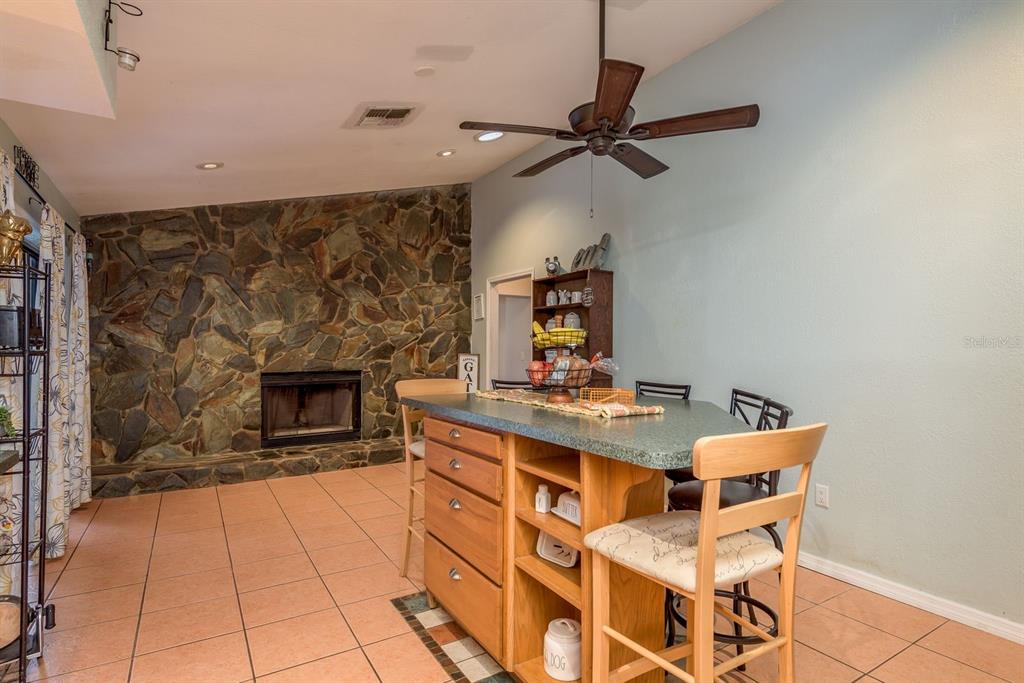 7487 Alhambra Court Spring Hill, FL 34606 - Photo 18 of 58 a open kitchen with a table and chairs