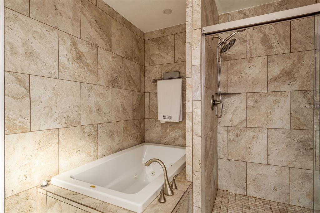 7487 Alhambra Court Spring Hill, FL 34606 - Photo 28 of 58 a bathroom with a bathtub and shower