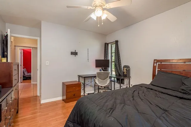 a bedroom with bed and a window