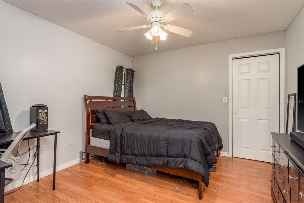 7487 Alhambra Court Spring Hill, FL 34606 - Photo 31 of 61 a bedroom with a bed and a chandelier