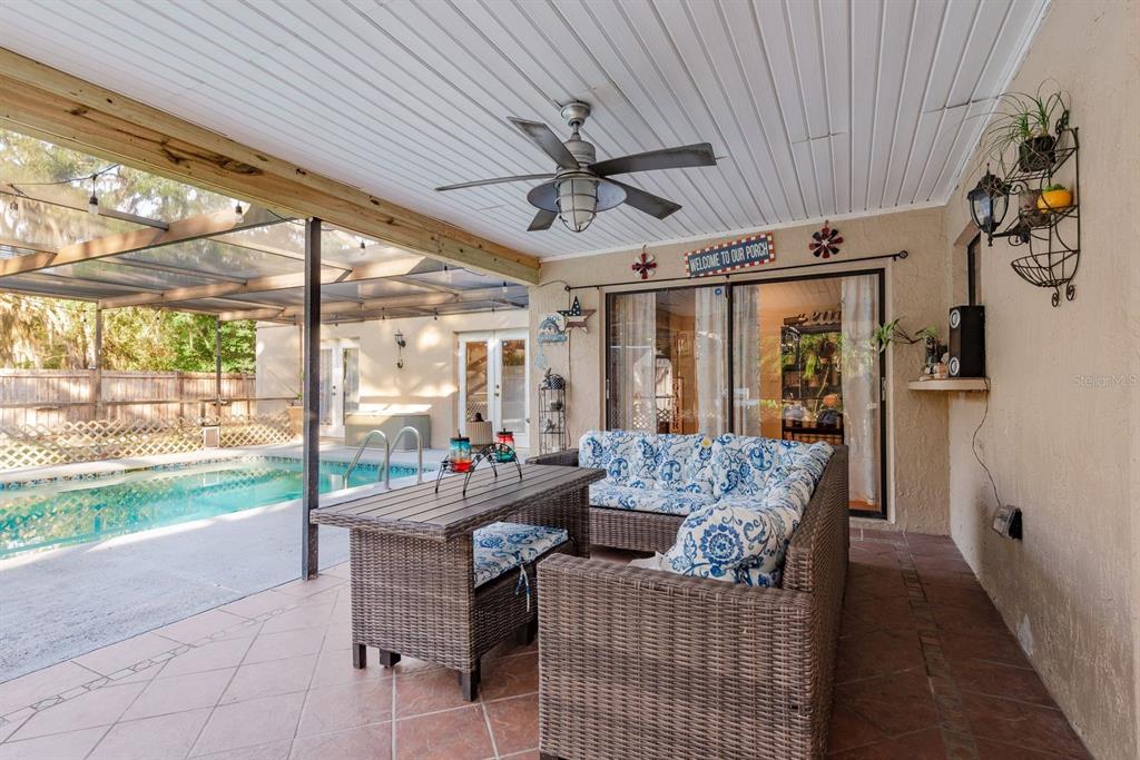 7487 Alhambra Court Spring Hill, FL 34606 - Photo 37 of 58 a living room with furniture and a floor to ceiling window