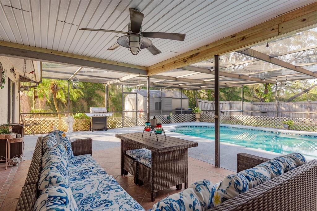 7487 Alhambra Court Spring Hill, FL 34606 - Photo 39 of 58 a living room with couch and a floor to ceiling window