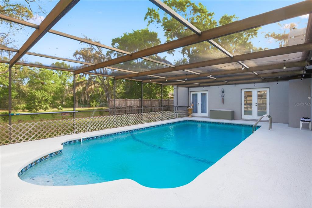 7487 Alhambra Court Spring Hill, FL 34606 - Photo 4 of 61 a view of a backyard with a swimming pool