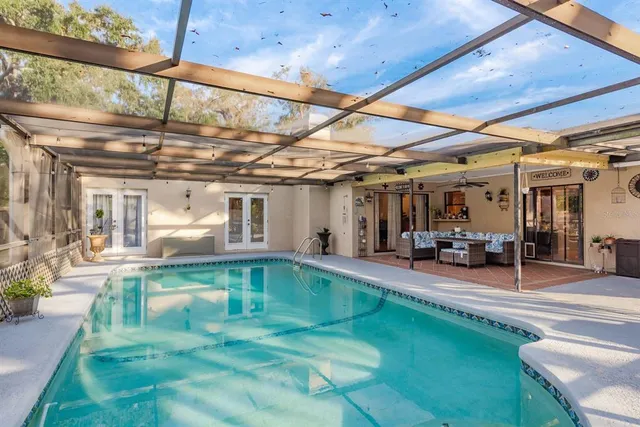 a view of a house with backyard and sitting area
