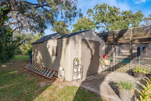 a view of backyard with wooden fence