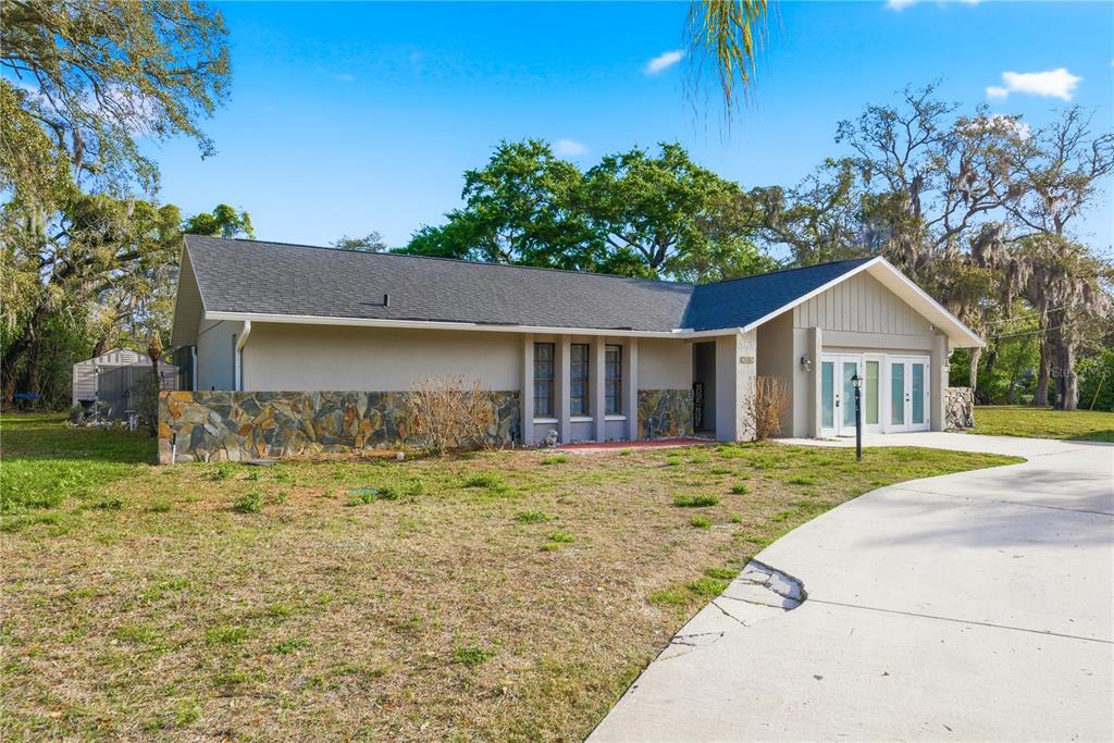 7487 Alhambra Court Spring Hill, FL 34606 - Photo 45 of 61 a front view of a house with a yard
