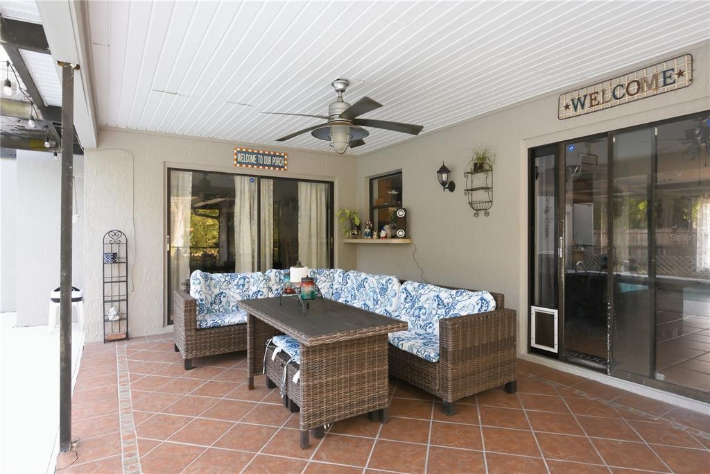 7487 Alhambra Court Spring Hill, FL 34606 - Photo 47 of 61 a living room with furniture and a chandelier
