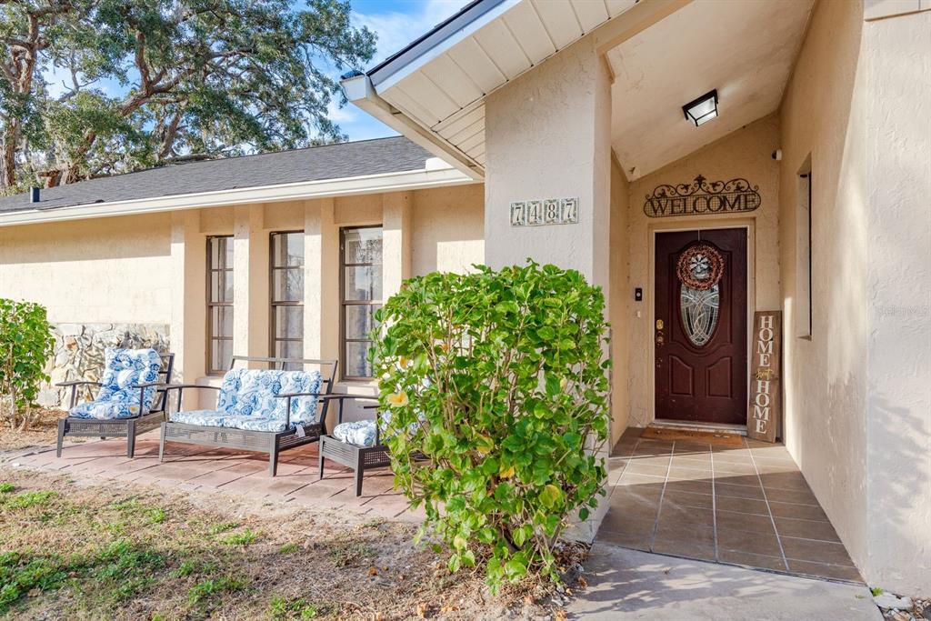 7487 Alhambra Court Spring Hill, FL 34606 - Photo 50 of 58 a front view of a house with garden
