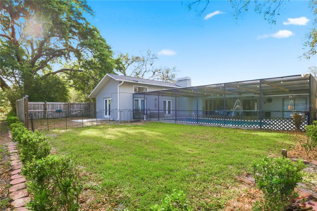 7487 Alhambra Court Spring Hill, FL 34606 - Photo 55 of 61 a view of a house with a backyard and balcony