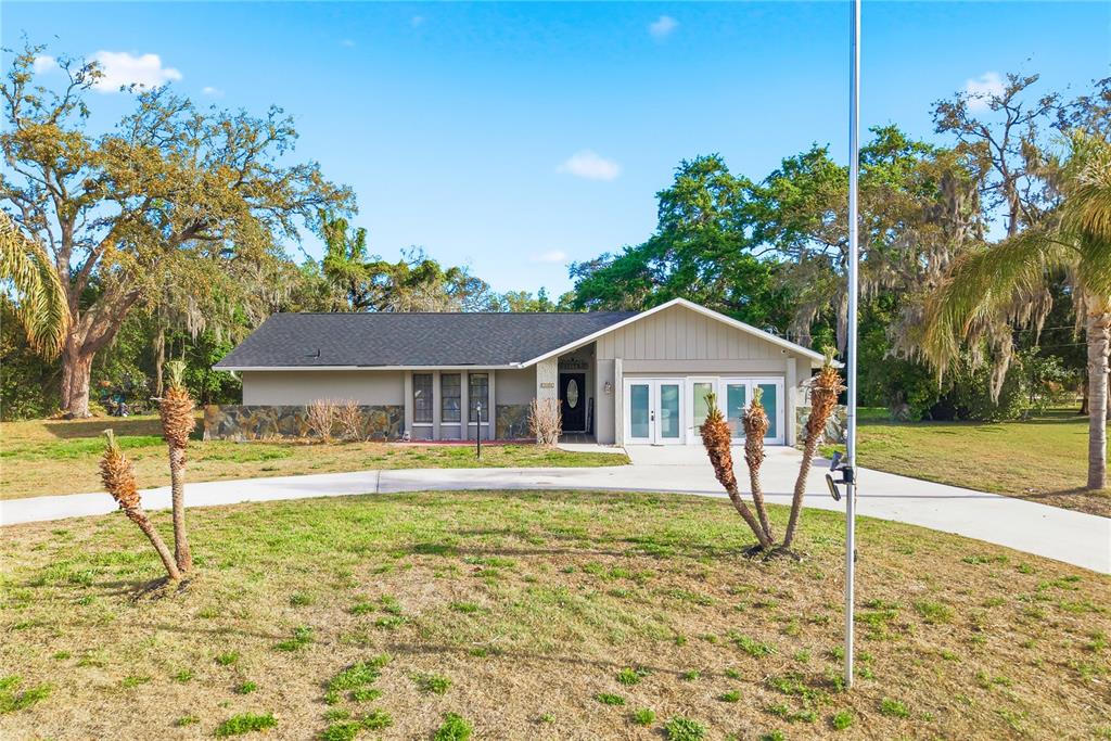 7487 Alhambra Court Spring Hill, FL 34606 - Photo 58 of 61 a house view with a garden space