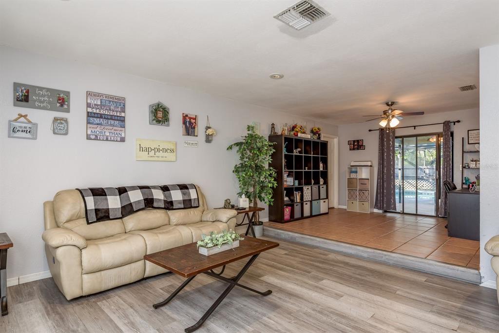 7487 Alhambra Court Spring Hill, FL 34606 - Photo 10 of 61 a living room with furniture and wooden floor