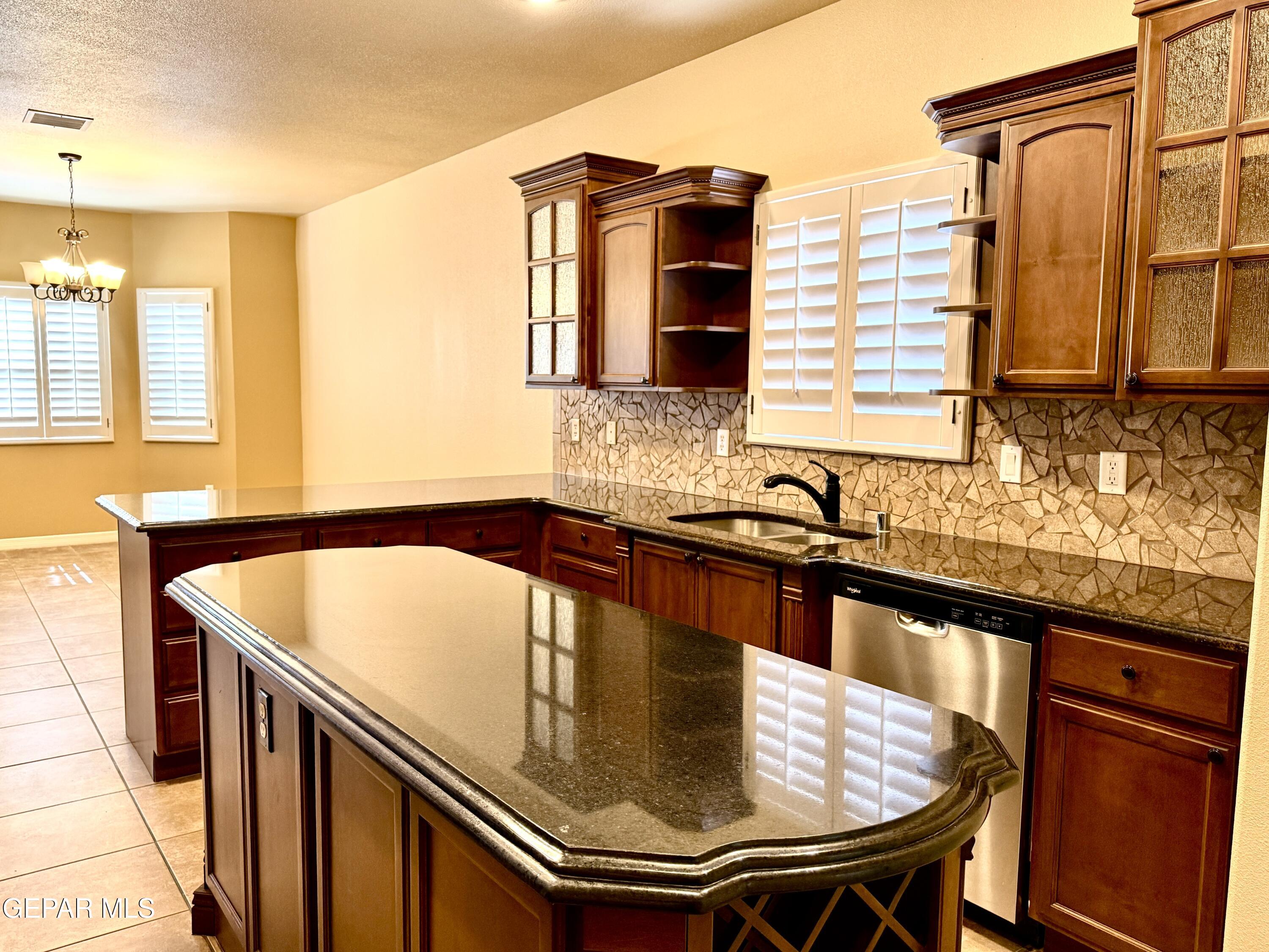 3060 Solar Point Lane El Paso, TX 79938 - Photo 20 of 49 a kitchen with a sink and a refrigerator