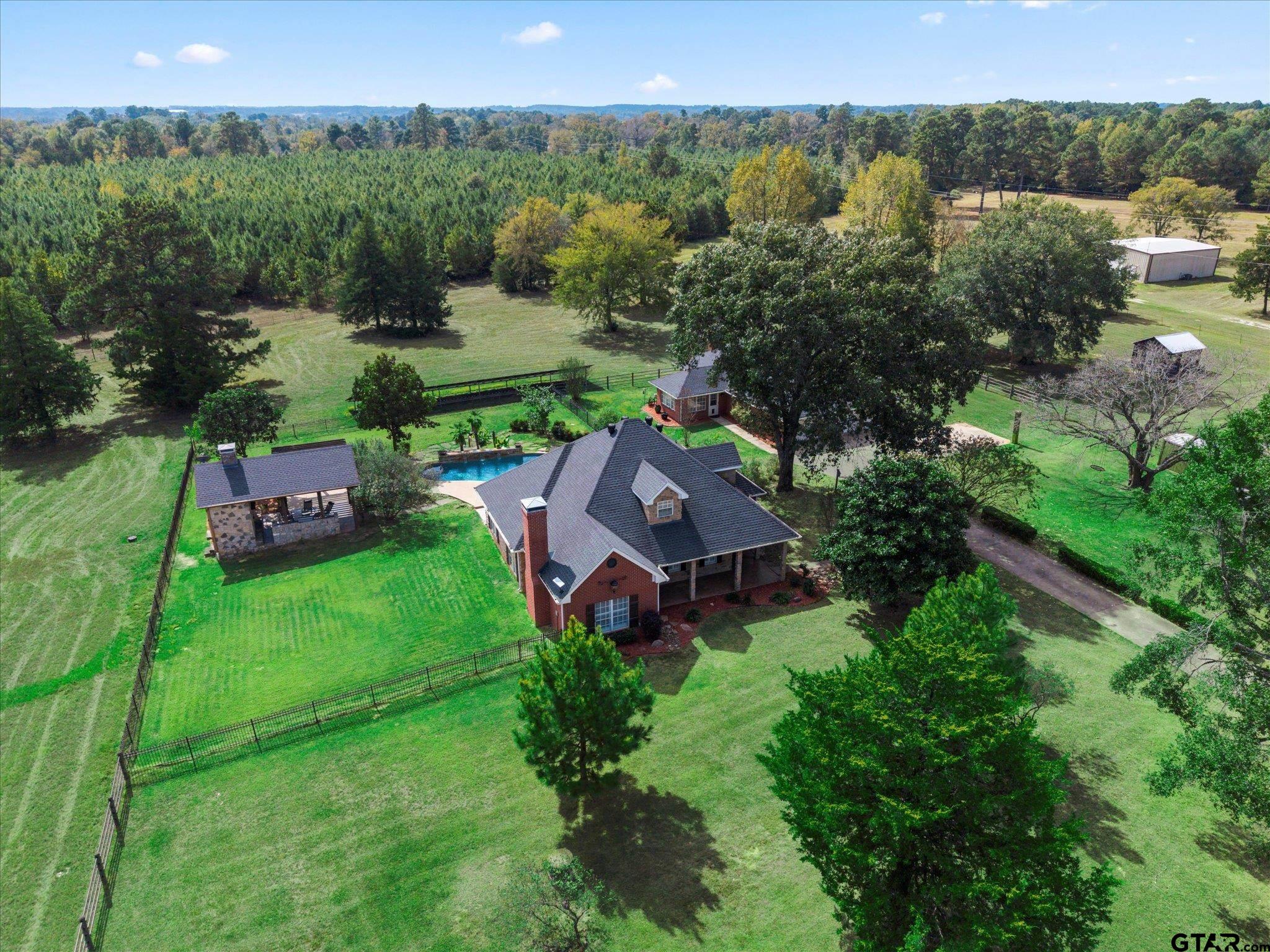 1879 Fig Road Gilmer, TX 75645 - Photo 1 of 46 an aerial view of a house with garden