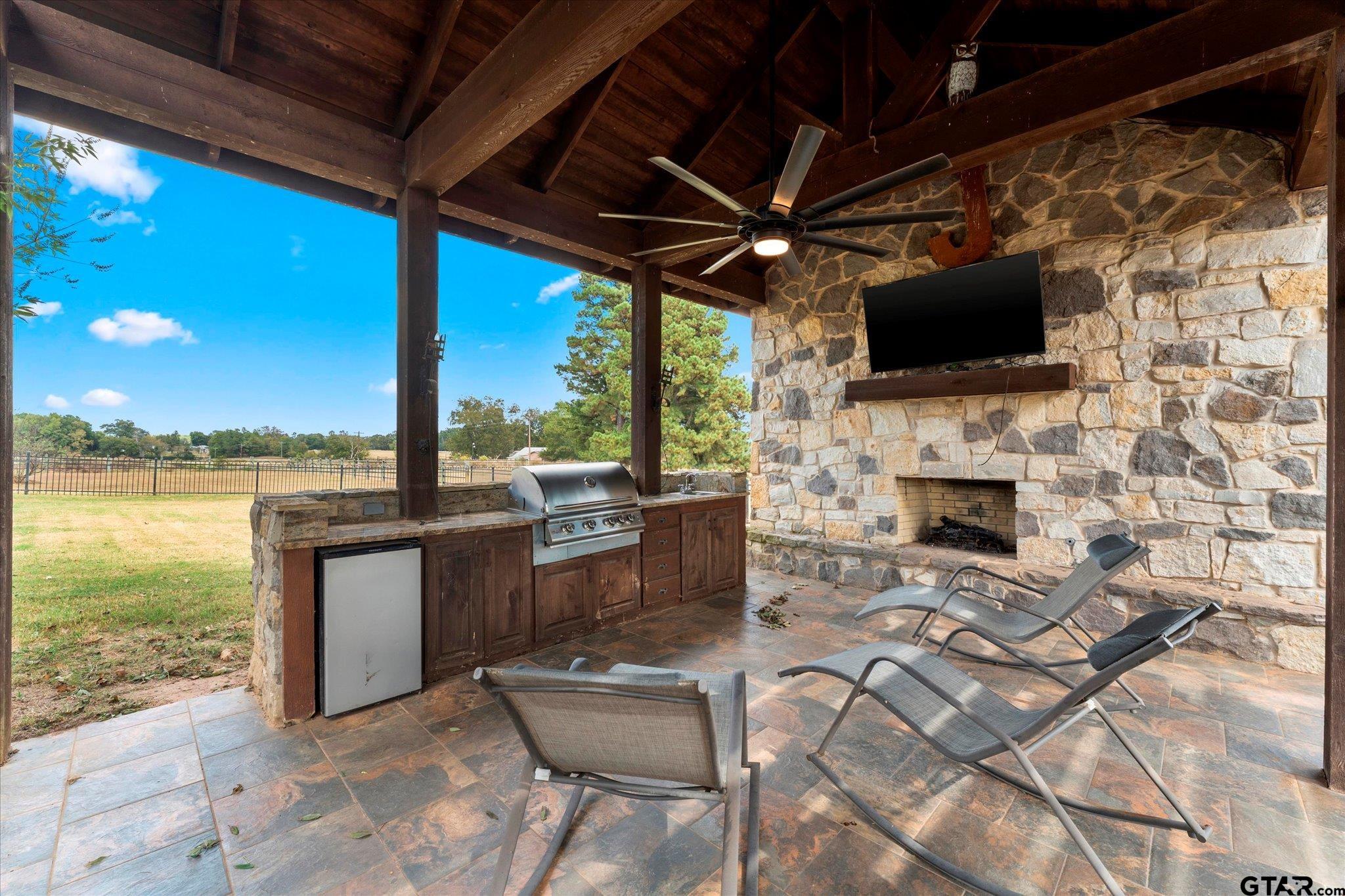 1879 Fig Road Gilmer, TX 75645 - Photo 13 of 46 a living room with fireplace furniture and a flat screen tv