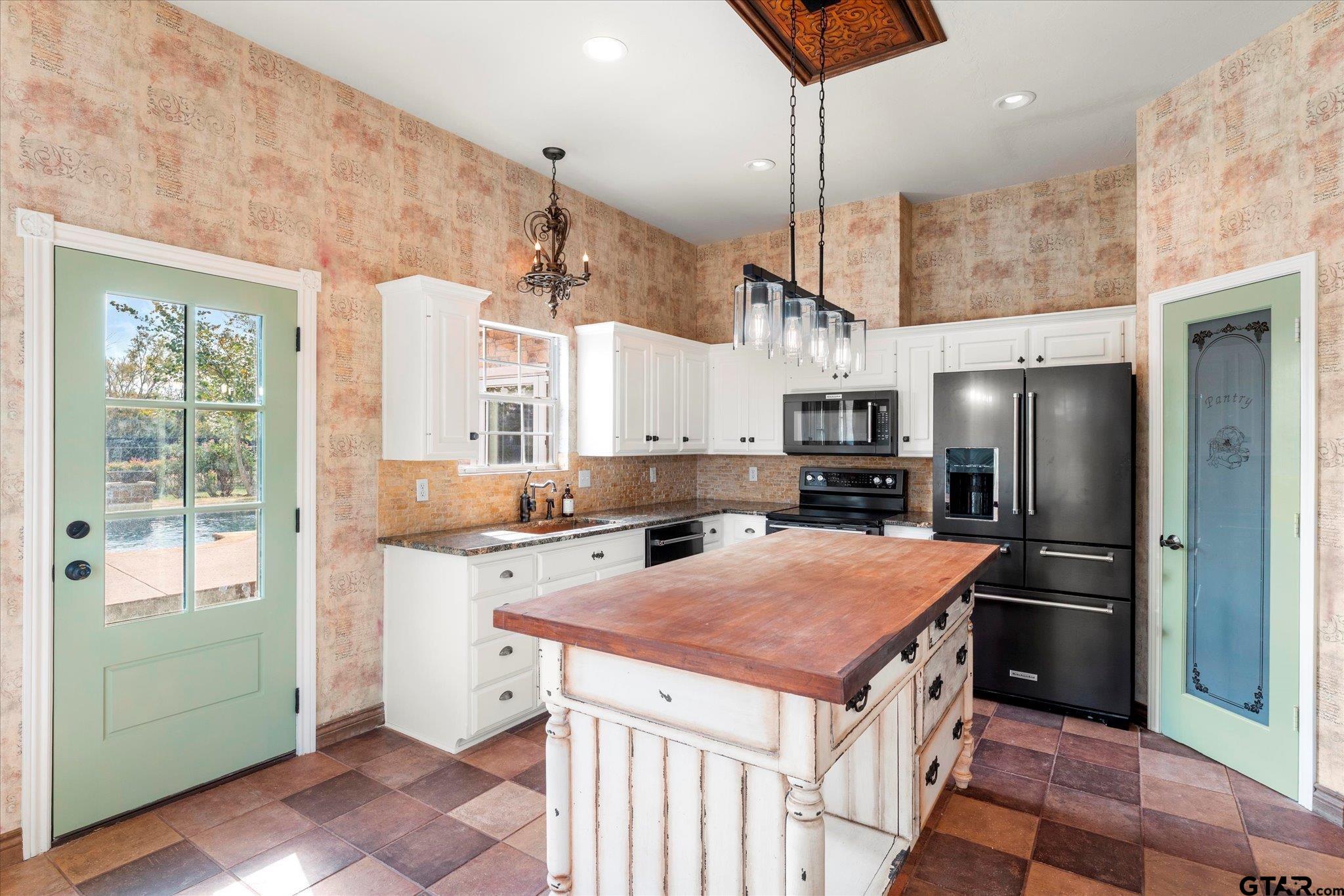 1879 Fig Road Gilmer, TX 75645 - Photo 19 of 46 a kitchen with a stove a refrigerator and a sink