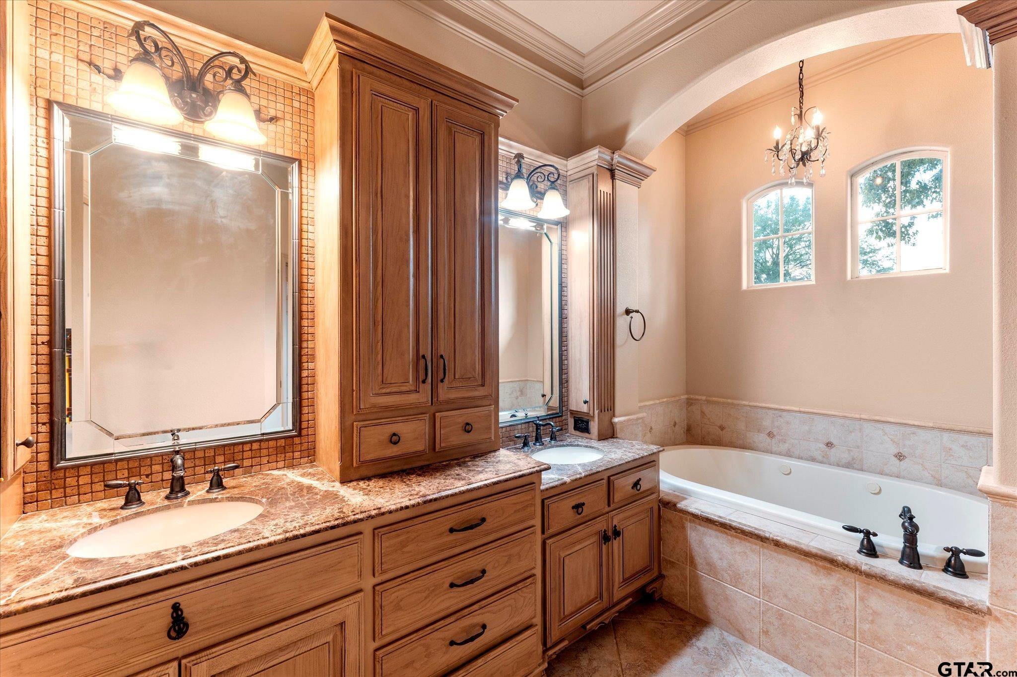 1879 Fig Road Gilmer, TX 75645 - Photo 22 of 46 a bathroom with a granite countertop tub sink and mirror