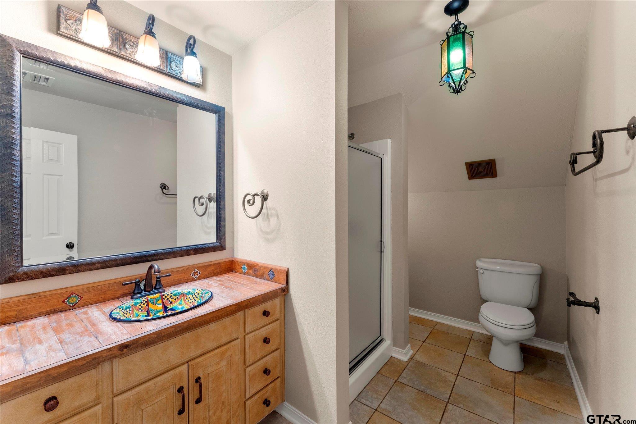 1879 Fig Road Gilmer, TX 75645 - Photo 26 of 46 a bathroom with a sink a toilet and mirror