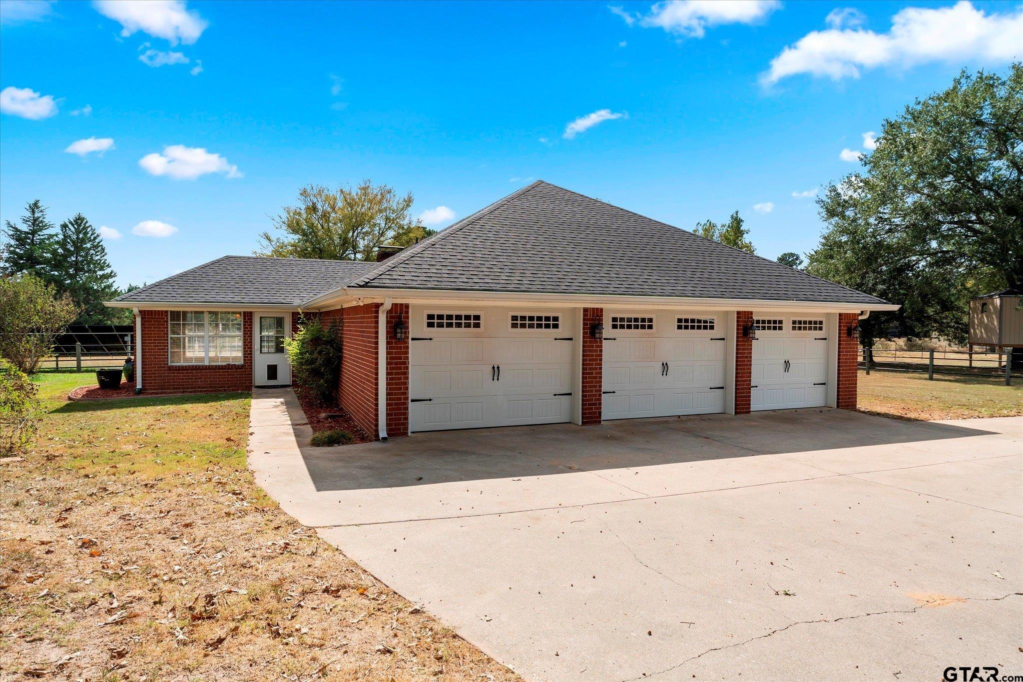 1879 Fig Road Gilmer, TX 75645 - Photo 30 of 46 a front view of a house with a yard