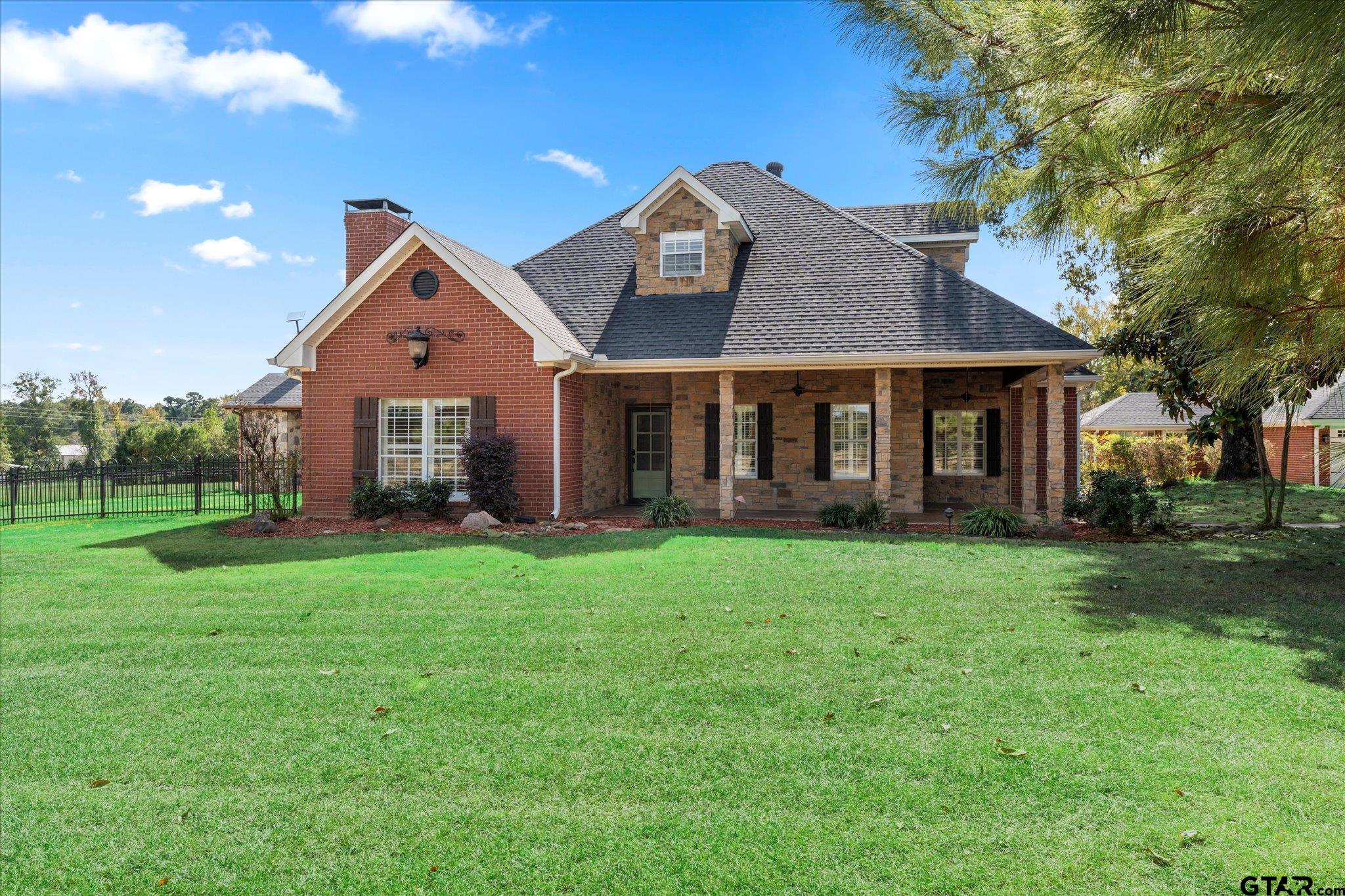 1879 Fig Road Gilmer, TX 75645 - Photo 4 of 46 a front view of a house with a yard