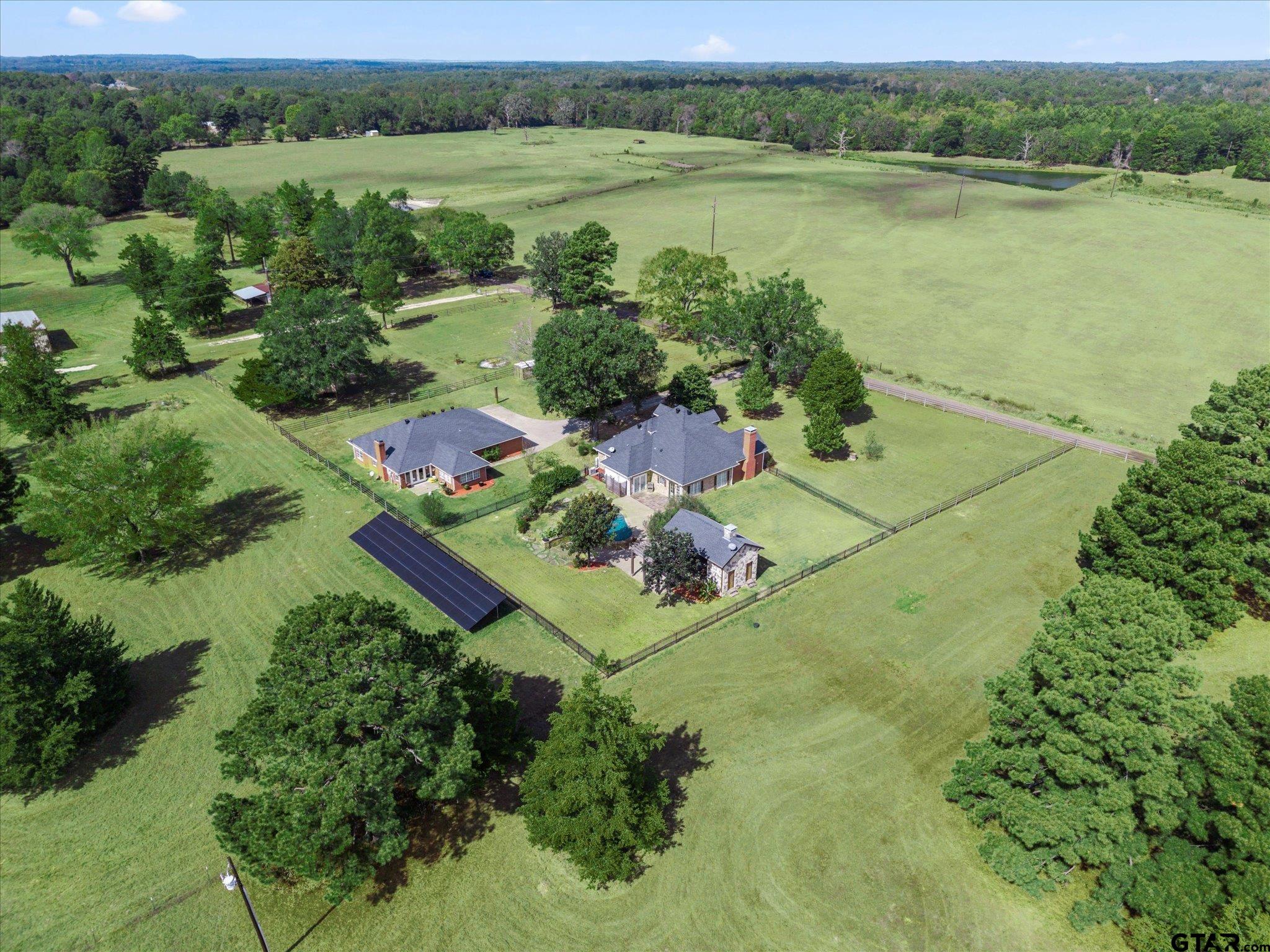 1879 Fig Road Gilmer, TX 75645 - Photo 6 of 46 an aerial view of green landscape with trees houses and lake view