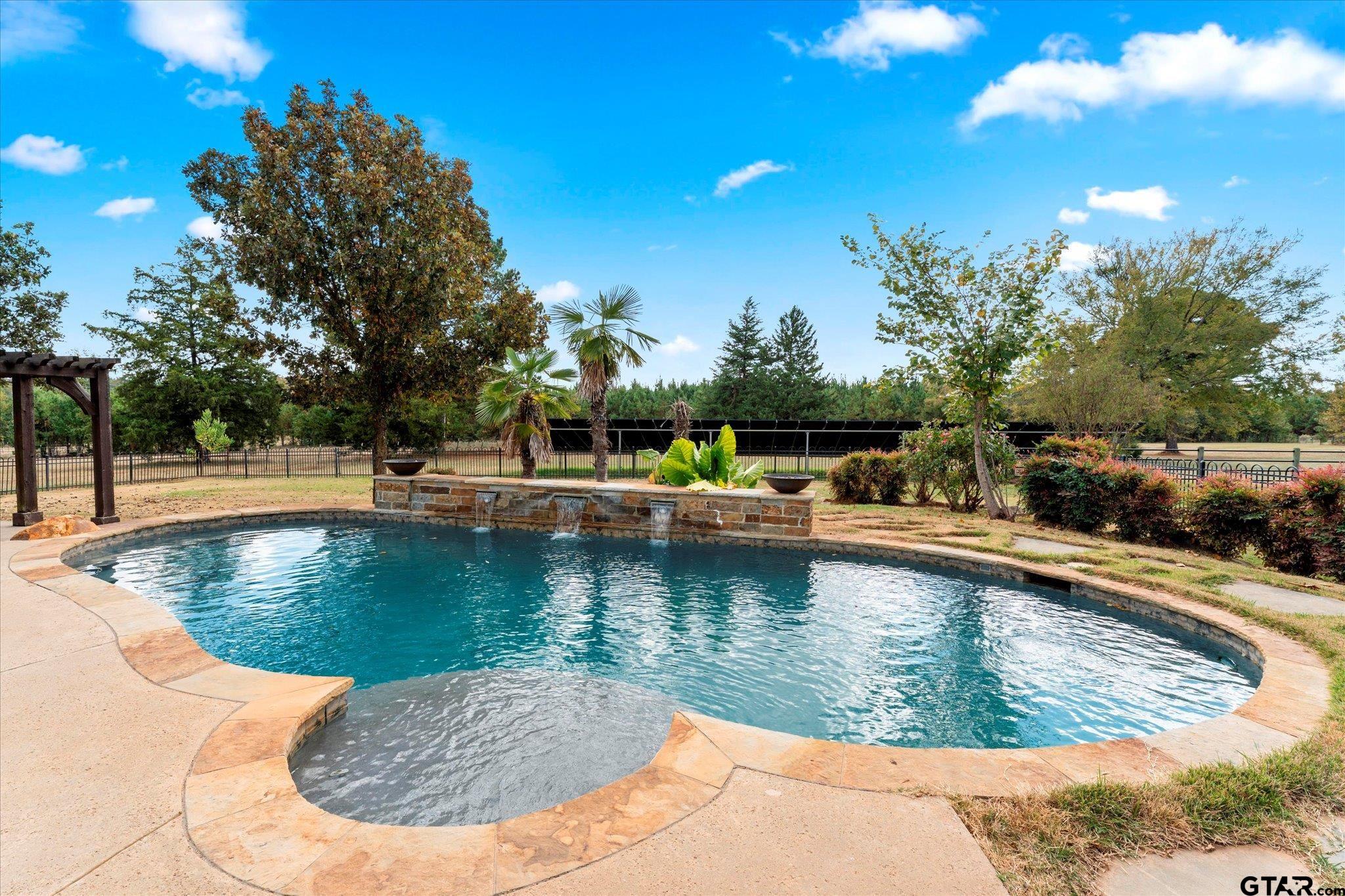 1879 Fig Road Gilmer, TX 75645 - Photo 8 of 46 a view of a swimming pool with a sitting space