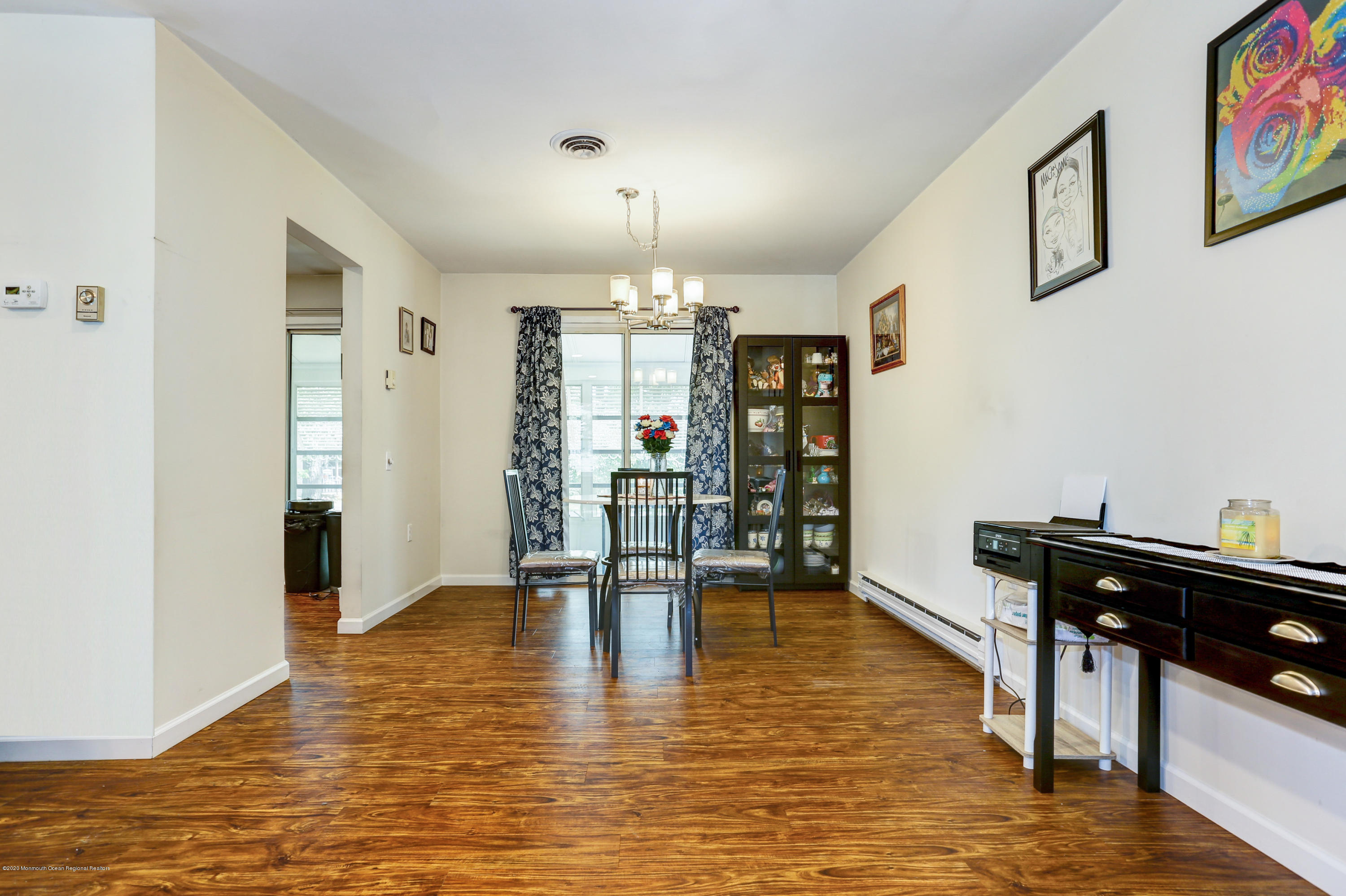 84 Sunset Road, Unit 60 Whiting, NJ 08759 - Photo 17 of 51 a dining room with furniture a chandelier and wooden floor