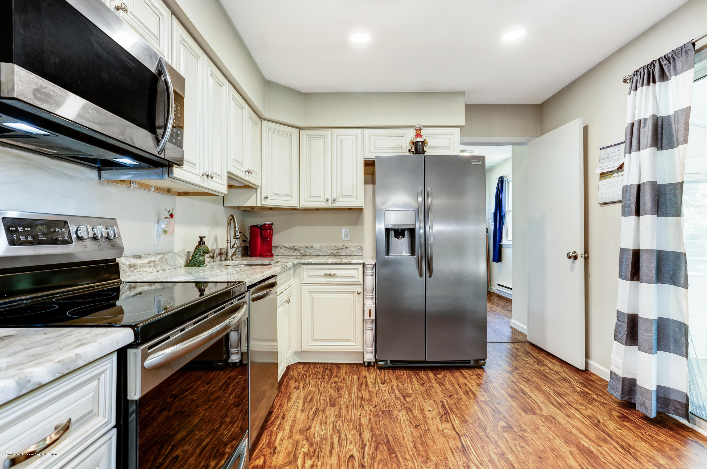 84 Sunset Road, Unit 60 Whiting, NJ 08759 - Photo 23 of 51 a kitchen with stainless steel appliances granite countertop a stove a refrigerator and a microwave
