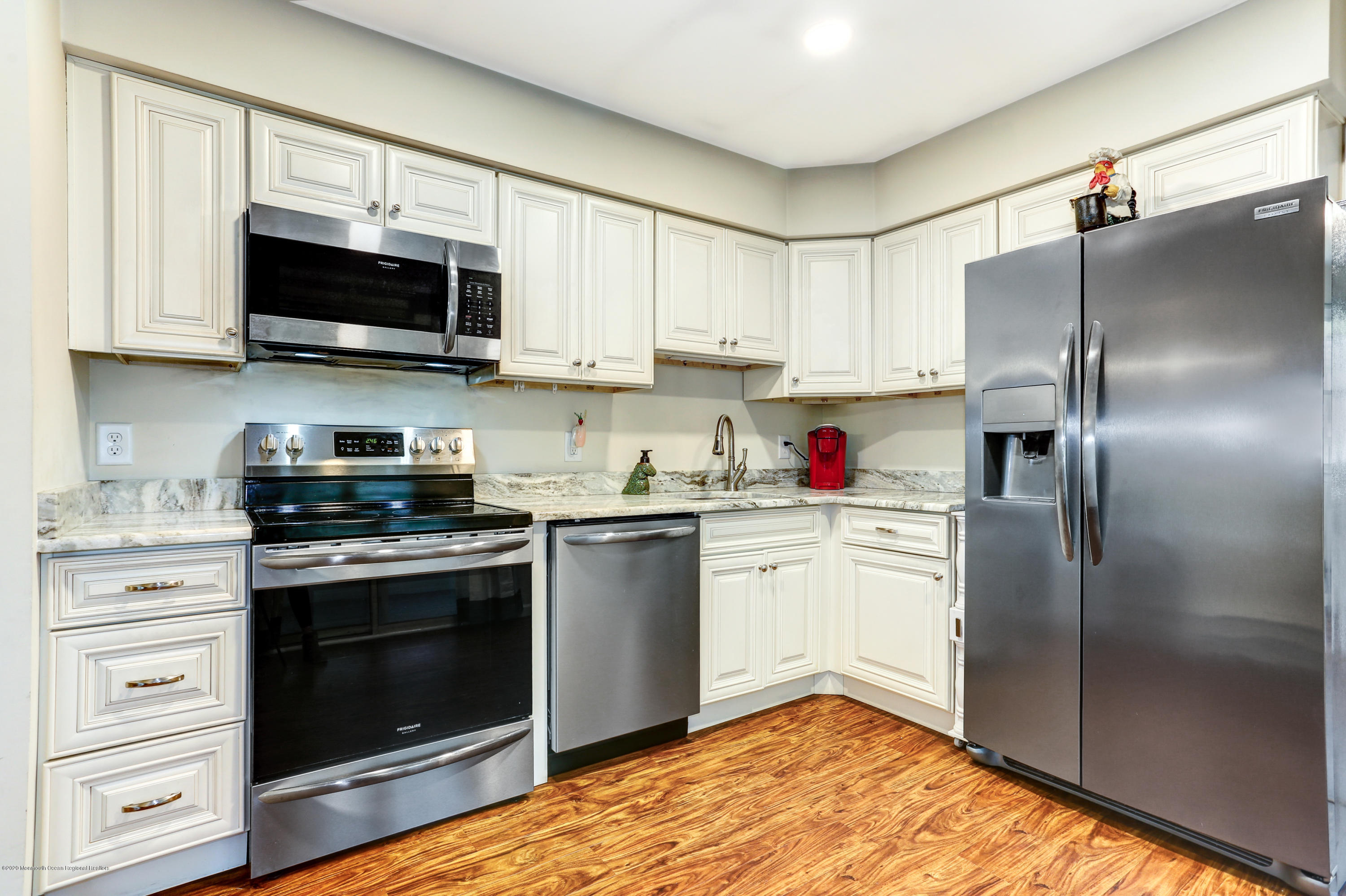 84 Sunset Road, Unit 60 Whiting, NJ 08759 - Photo 25 of 51 a kitchen with stainless steel appliances granite countertop a refrigerator stove and white cabinets