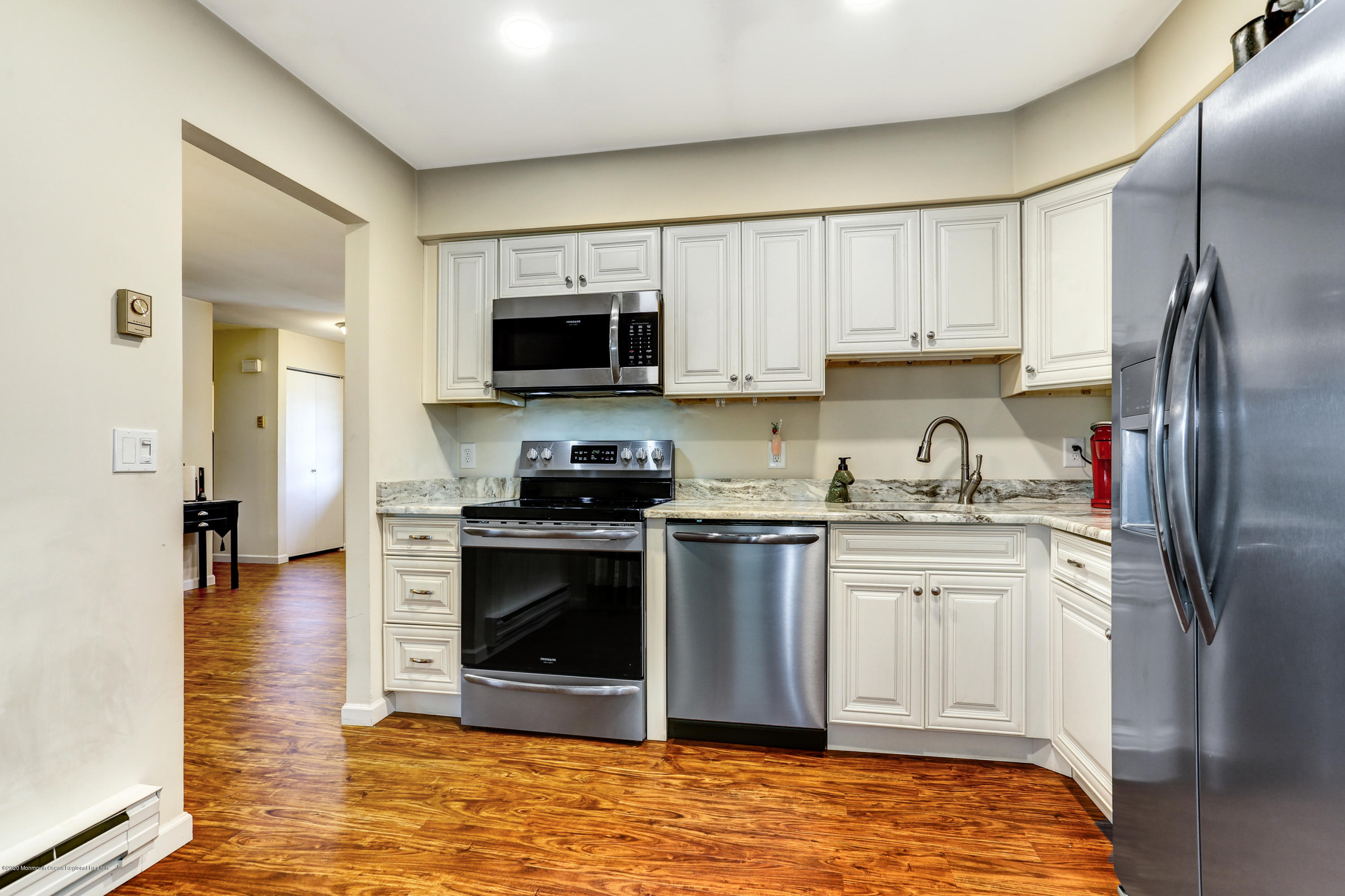 84 Sunset Road, Unit 60 Whiting, NJ 08759 - Photo 26 of 51 a kitchen with stainless steel appliances granite countertop a stove a sink and a refrigerator