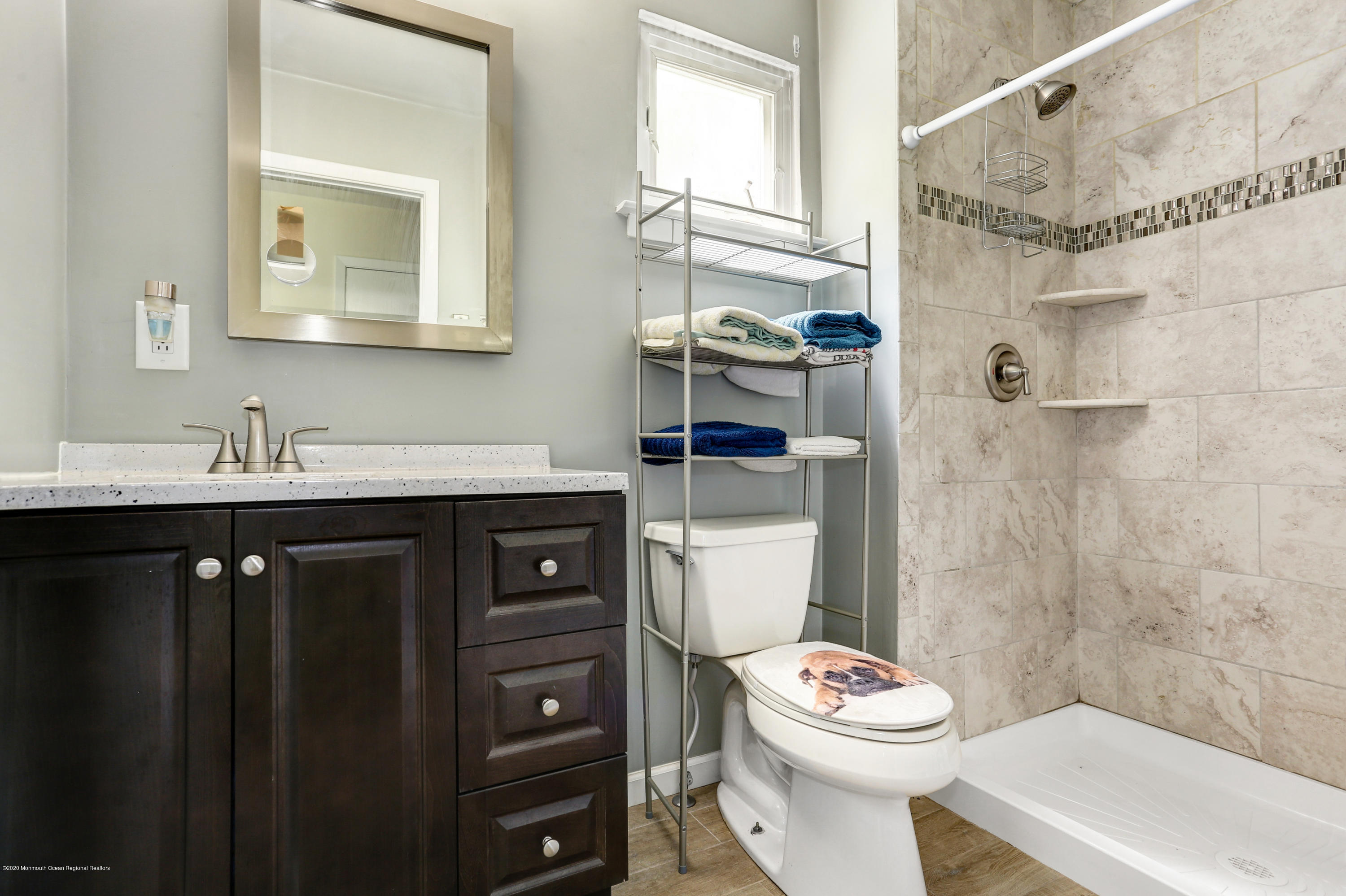 84 Sunset Road, Unit 60 Whiting, NJ 08759 - Photo 38 of 51 a bathroom with a granite countertop toilet sink and mirror
