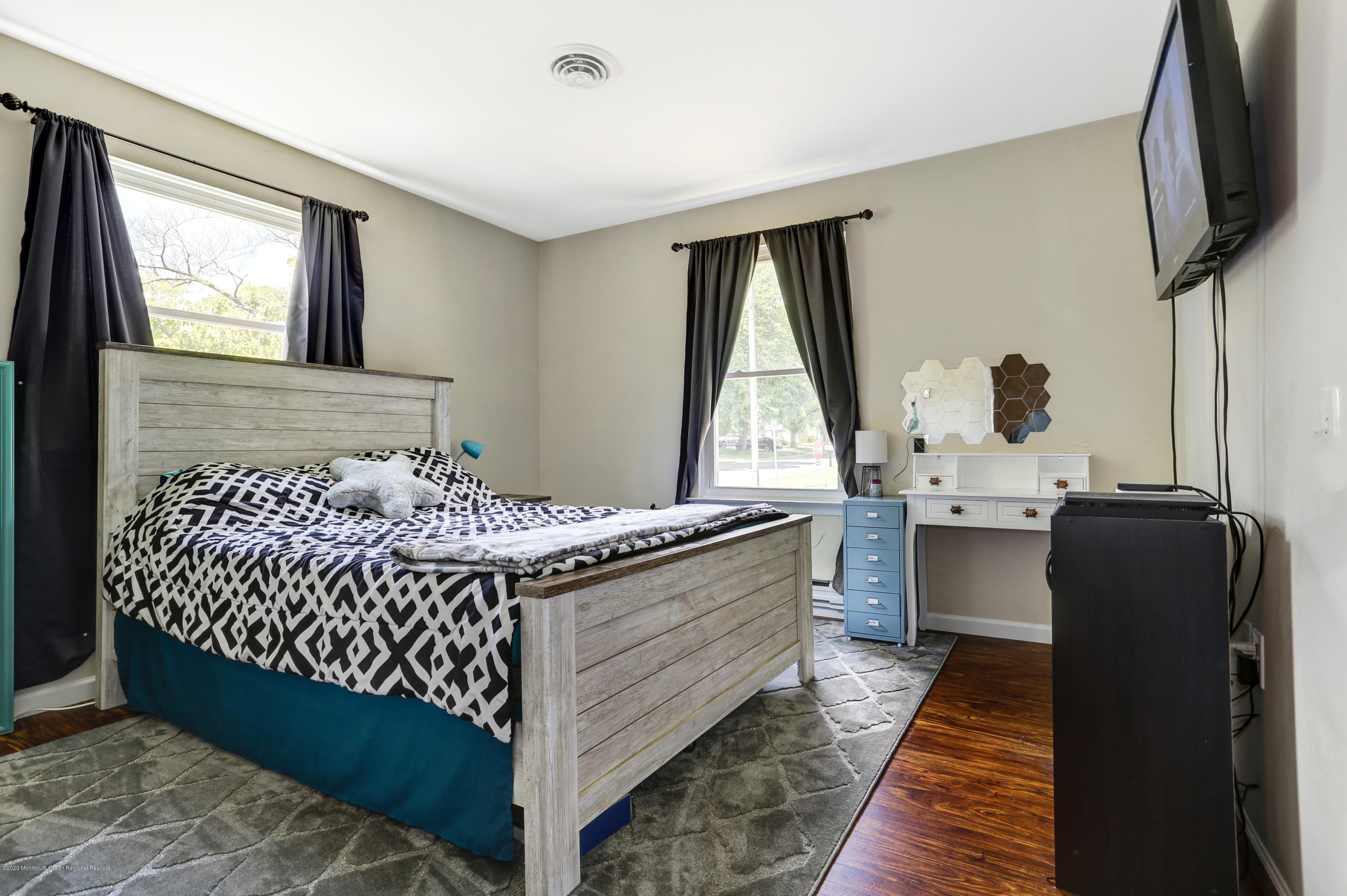 84 Sunset Road, Unit 60 Whiting, NJ 08759 - Photo 40 of 51 a bedroom with a bed and wooden floor