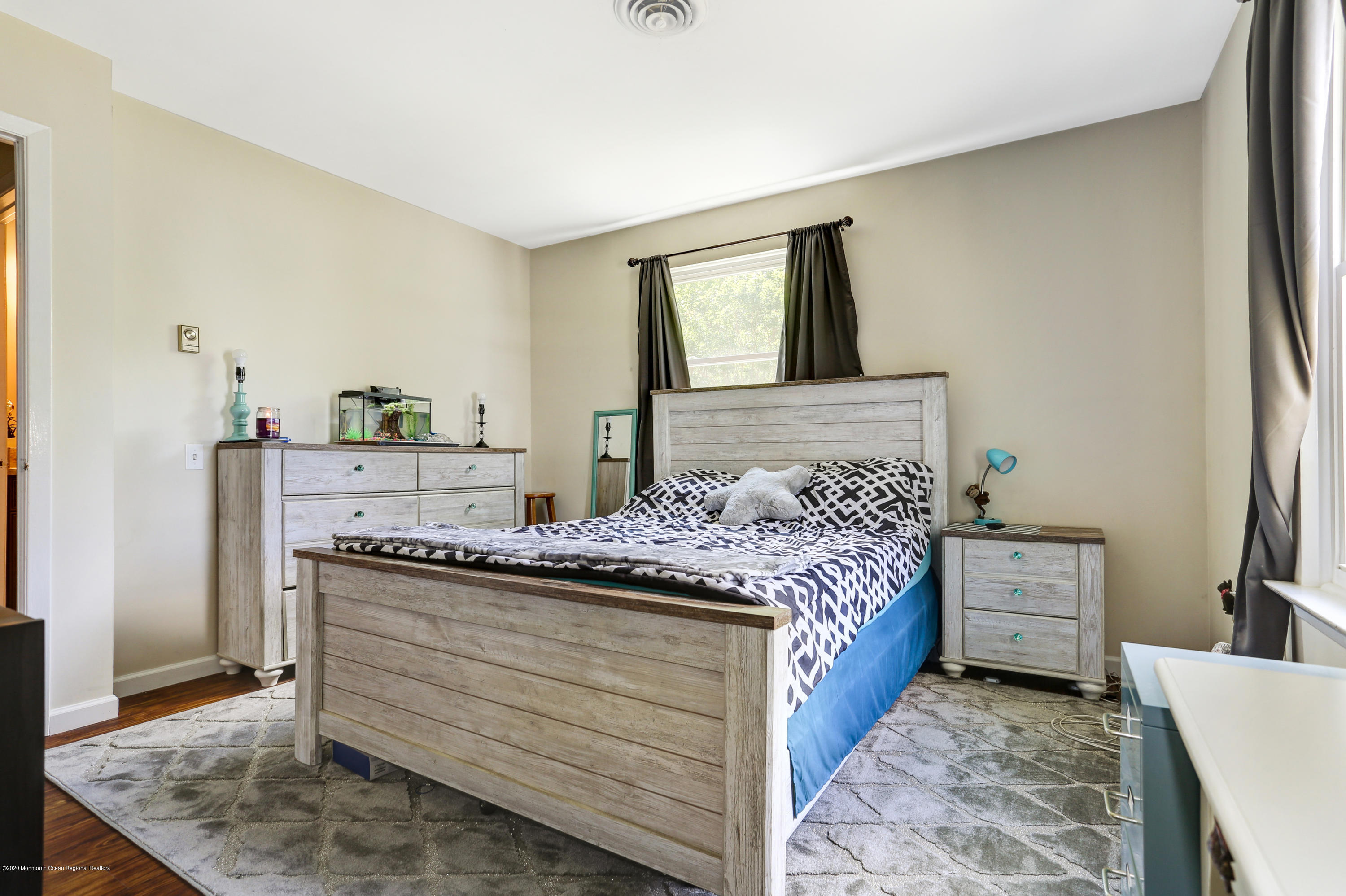 84 Sunset Road, Unit 60 Whiting, NJ 08759 - Photo 41 of 51 a bedroom with a bed and a dresser in it