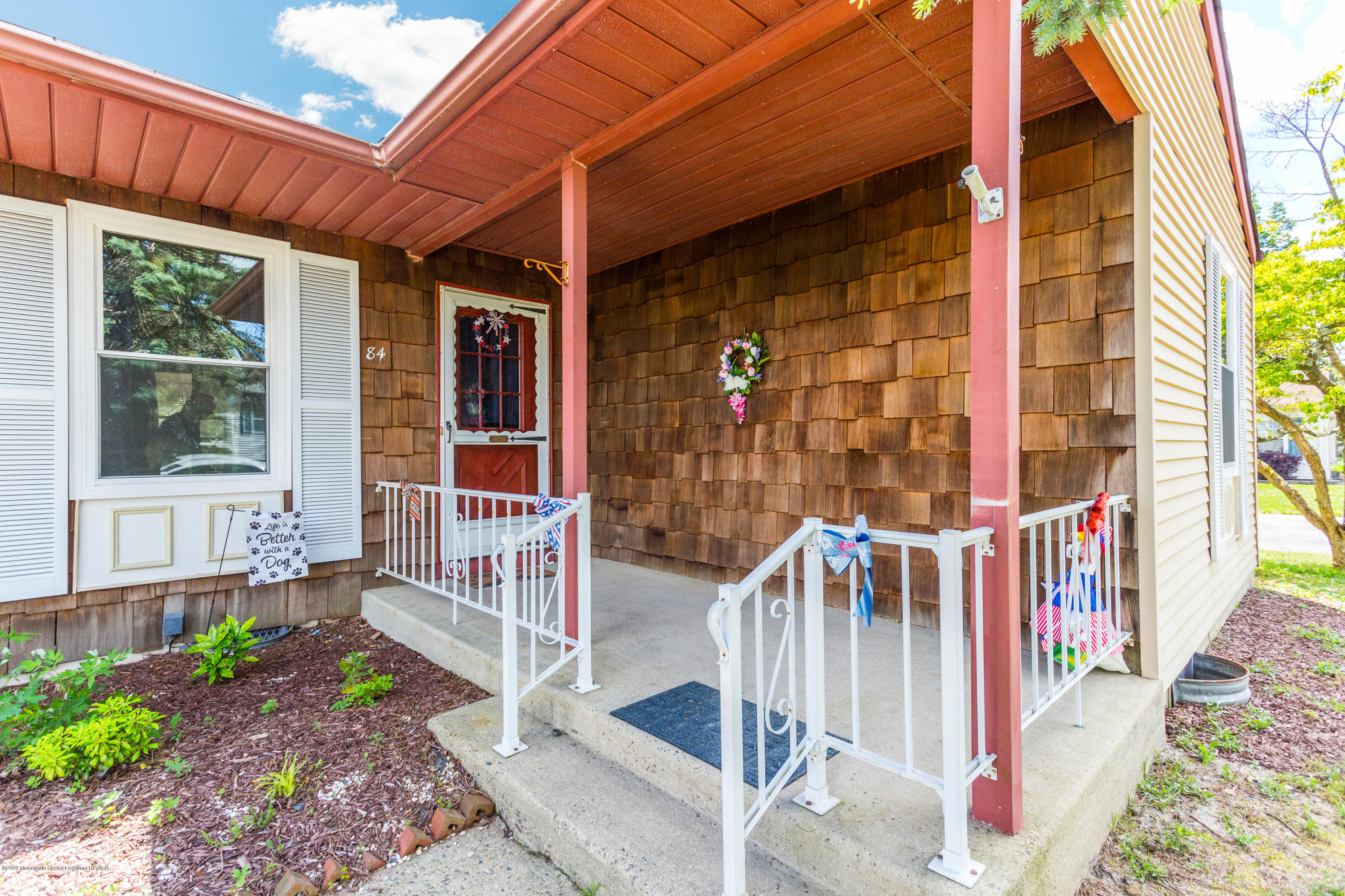 84 Sunset Road, Unit 60 Whiting, NJ 08759 - Photo 44 of 51 a front view of a house with a porch