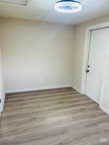 a view of a room with wooden floor