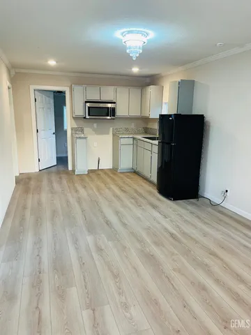 a large kitchen with a refrigerator and a sink