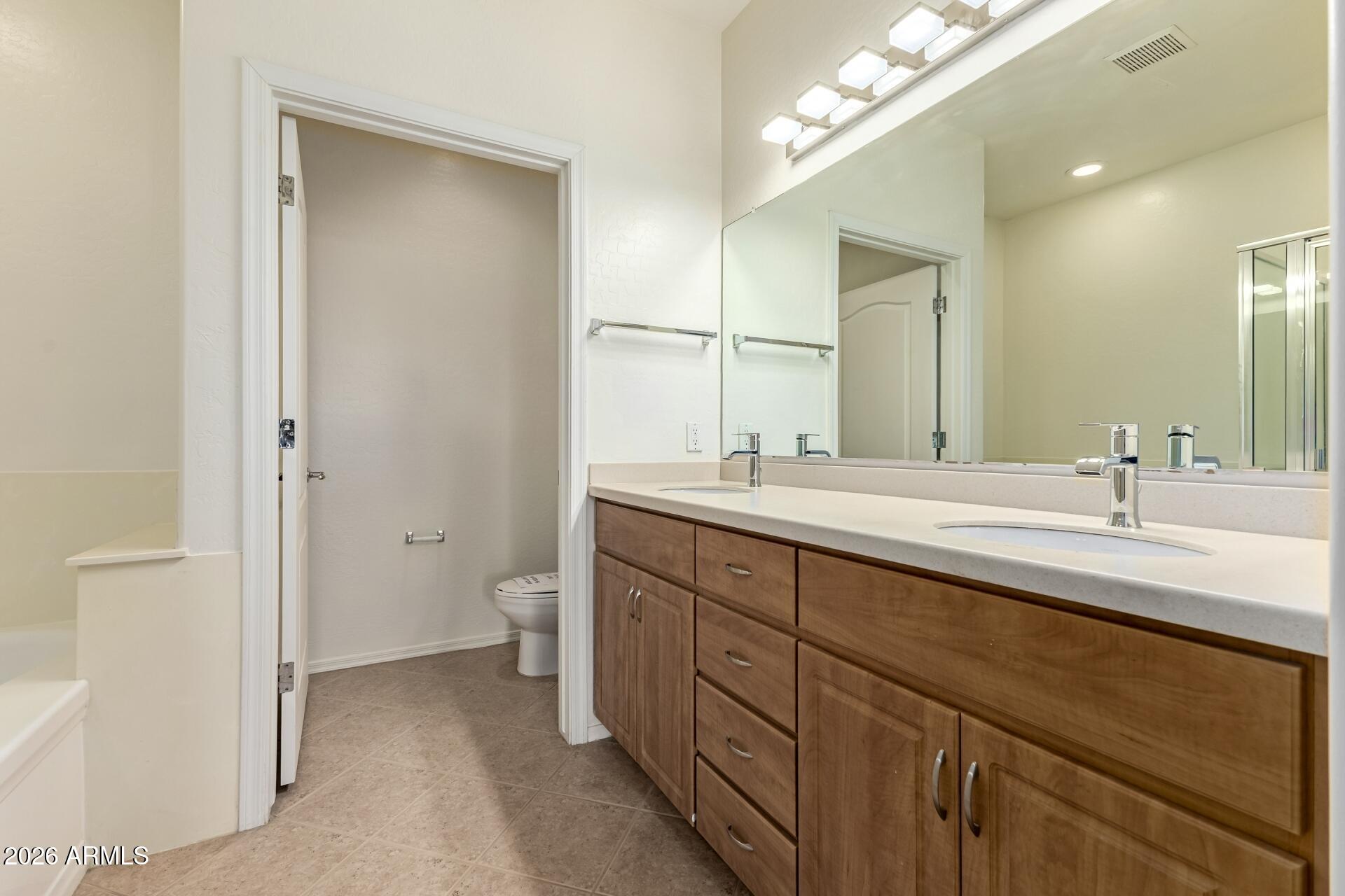 705 West Queen Creek Road, Unit 1167 Chandler, AZ 85248 - Photo 18 of 31 a bathroom with a double vanity sink and a mirror