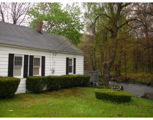 1355 Main Street Warren, MA 01083 - Photo 3 of 6 a view of a house with backyard sitting area and garden
