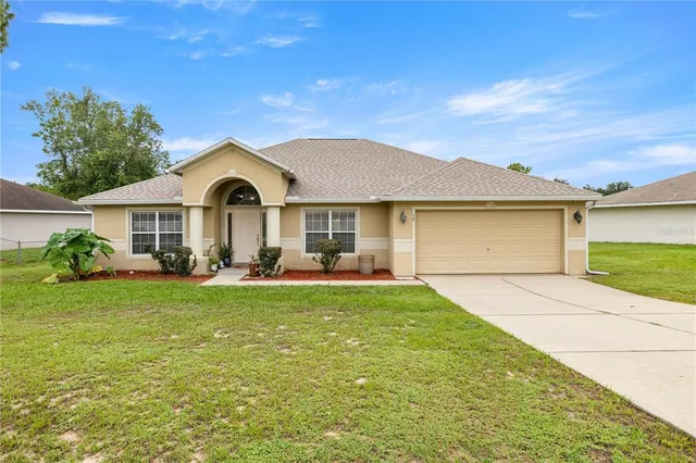 a front view of a house with a garden and porch
