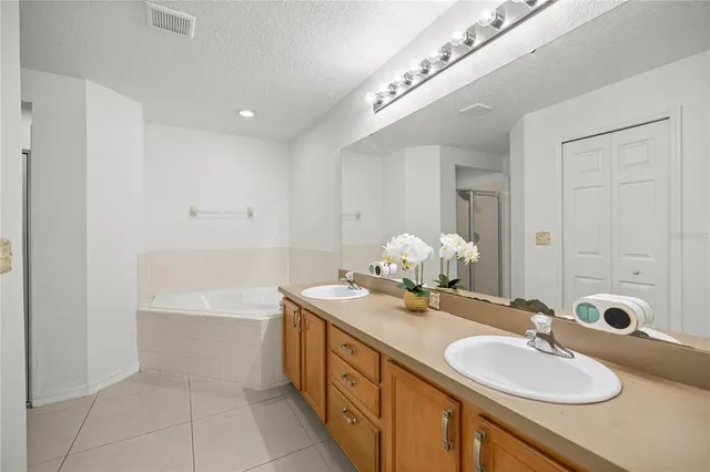 a bathroom with a double vanity sink and a mirror
