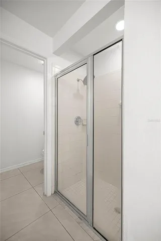 a bathroom with a glass shower door