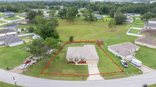 an aerial view of a house with outdoor space lake view