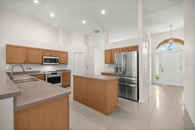 a kitchen with stainless steel appliances granite countertop a refrigerator oven a sink dishwasher and a refrigerator